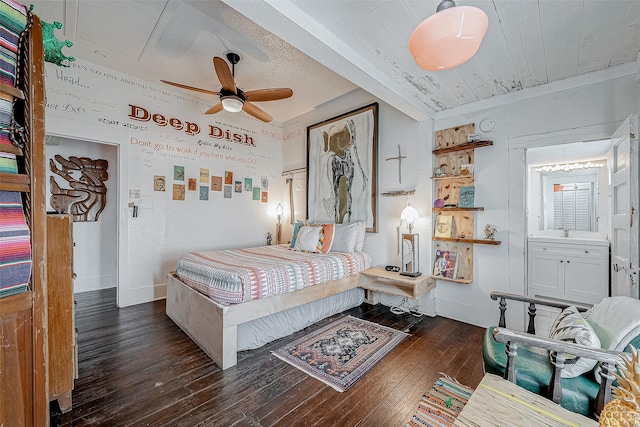 bedroom featuring dark wood-style floors, attic access, and baseboards