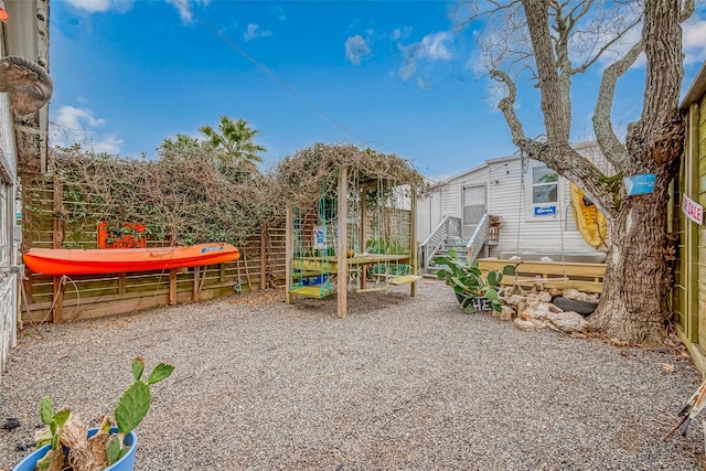 view of play area with entry steps and fence