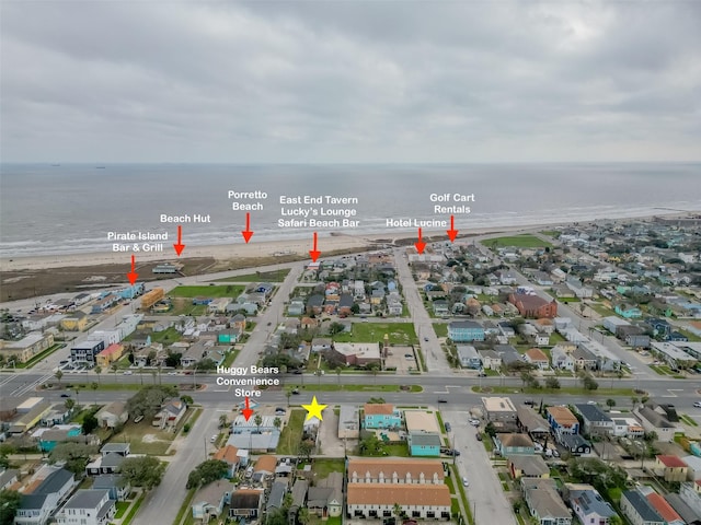 aerial view with a view of the beach, a residential view, and a water view