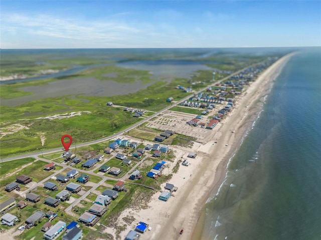 birds eye view of property with a water view and a view of the beach