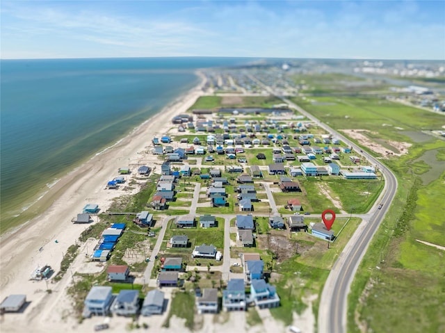 drone / aerial view with a water view, a residential view, and a view of the beach