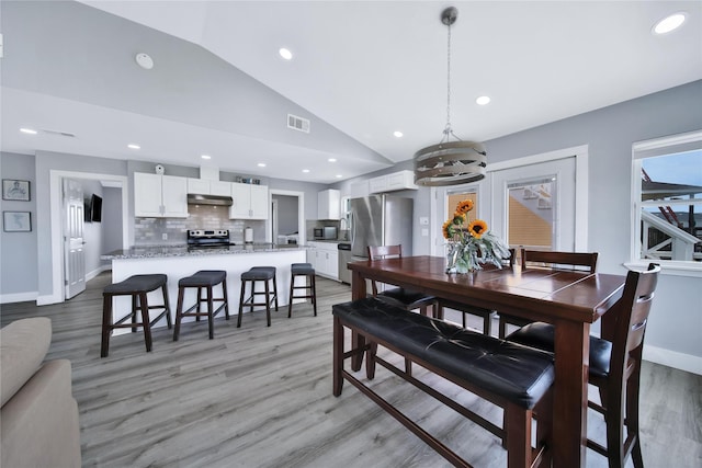 dining area featuring lofted ceiling, recessed lighting, visible vents, light wood-type flooring, and baseboards