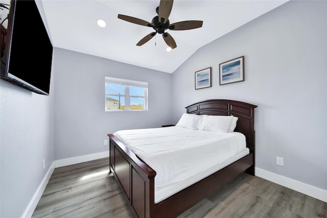 bedroom featuring lofted ceiling, ceiling fan, baseboards, and wood finished floors