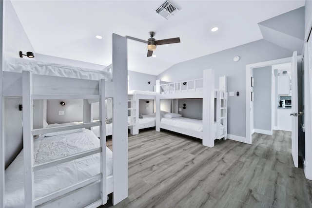 bedroom featuring recessed lighting, visible vents, baseboards, vaulted ceiling, and light wood-style floors