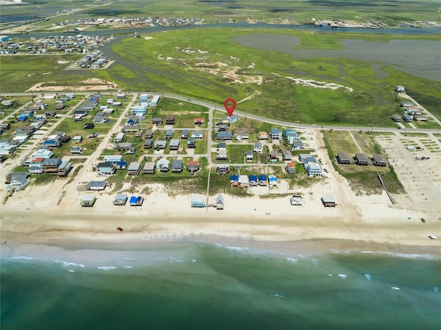 birds eye view of property featuring a view of the beach and a water view