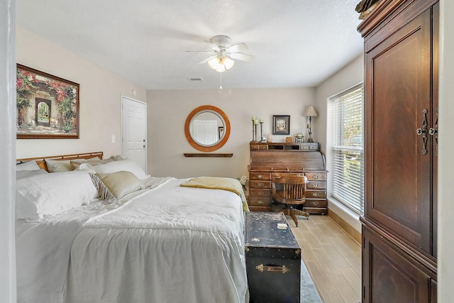 bedroom with ceiling fan, visible vents, and light wood-style floors