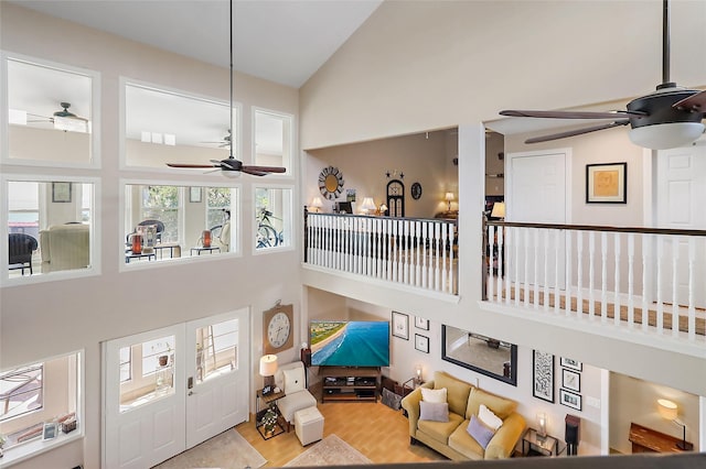 living room with high vaulted ceiling, ceiling fan, and wood finished floors