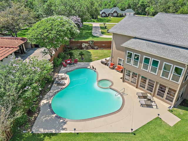 view of swimming pool with a patio, a fenced backyard, and a pool with connected hot tub