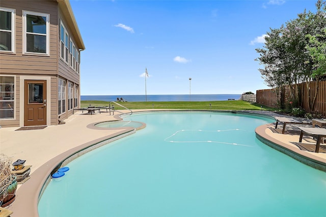 view of pool with a water view, a patio area, fence, and a fenced in pool