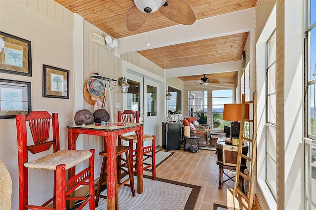 sunroom with wooden ceiling and a ceiling fan