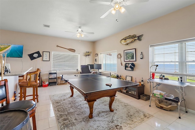 game room with a ceiling fan, visible vents, and light tile patterned floors