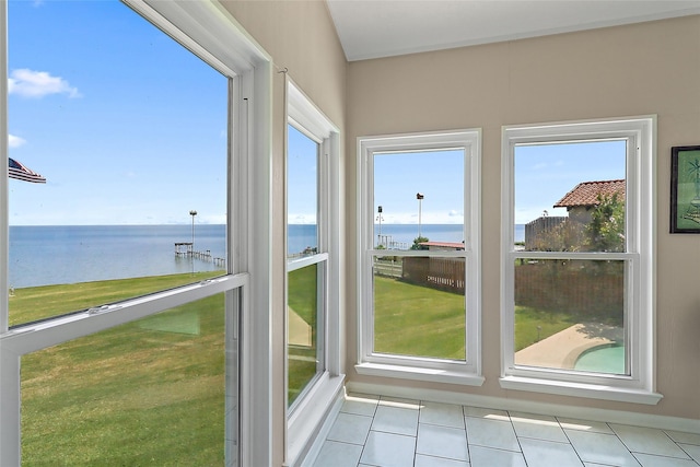 unfurnished sunroom featuring a water view