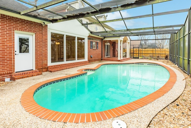 view of pool with a patio area, a lanai, a fenced in pool, and fence