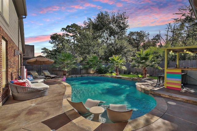 view of swimming pool featuring a patio area, a fenced backyard, and a fenced in pool