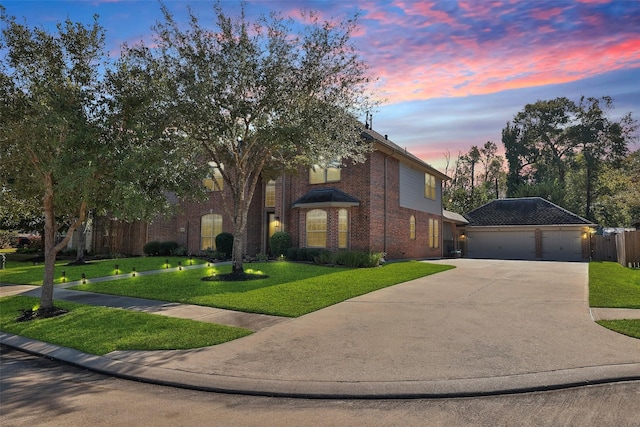 view of front facade featuring a garage, brick siding, an outdoor structure, driveway, and a front lawn