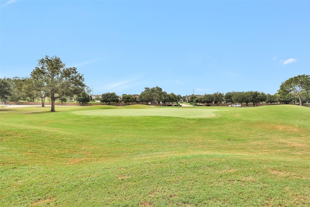 view of home's community with a yard and golf course view