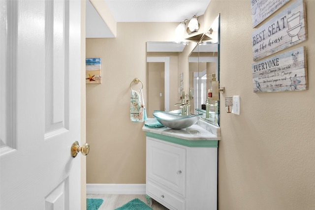 bathroom with vanity and baseboards