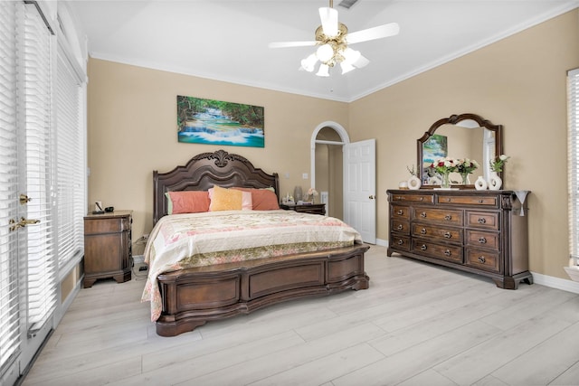 bedroom featuring light wood-style floors, ceiling fan, baseboards, and crown molding