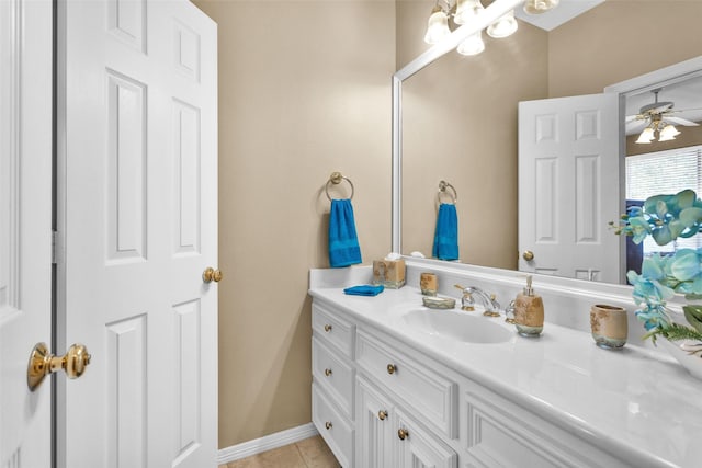 bathroom with a ceiling fan, tile patterned flooring, vanity, and baseboards