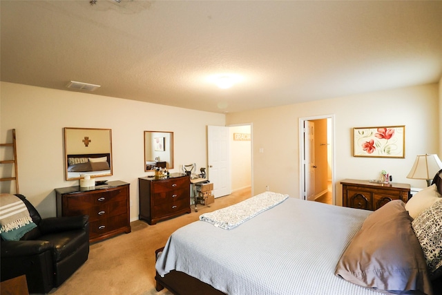 bedroom with visible vents and light colored carpet