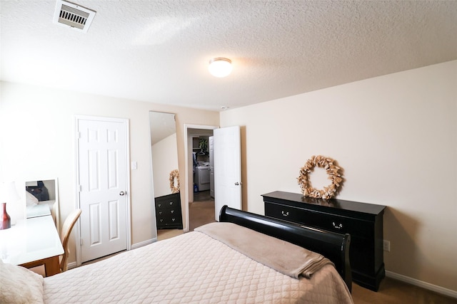 bedroom featuring baseboards, visible vents, a closet, and a textured ceiling