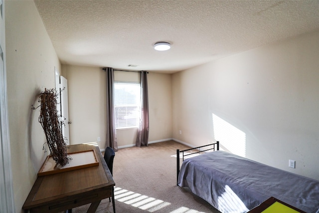 bedroom with baseboards, carpet, visible vents, and a textured ceiling