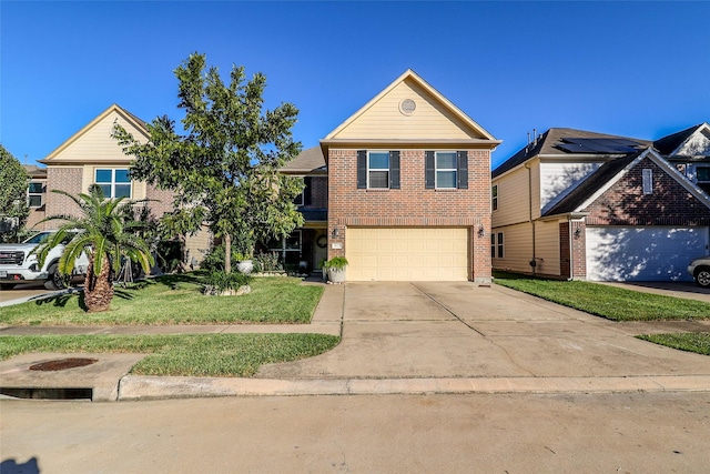 traditional-style house featuring a front yard, brick siding, an attached garage, and driveway