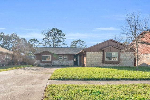 ranch-style house with board and batten siding, concrete driveway, brick siding, and a front lawn