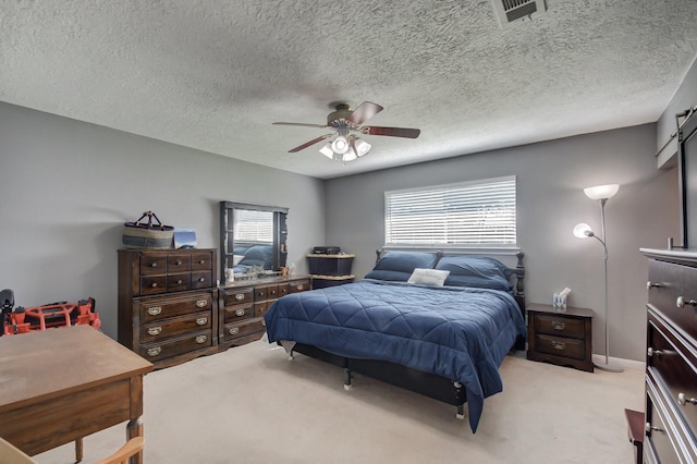 bedroom featuring visible vents, ceiling fan, light carpet, and multiple windows