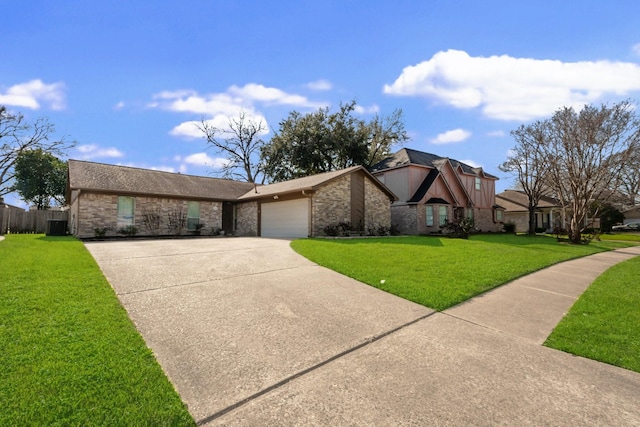 view of front of home featuring an attached garage, cooling unit, fence, driveway, and a front lawn