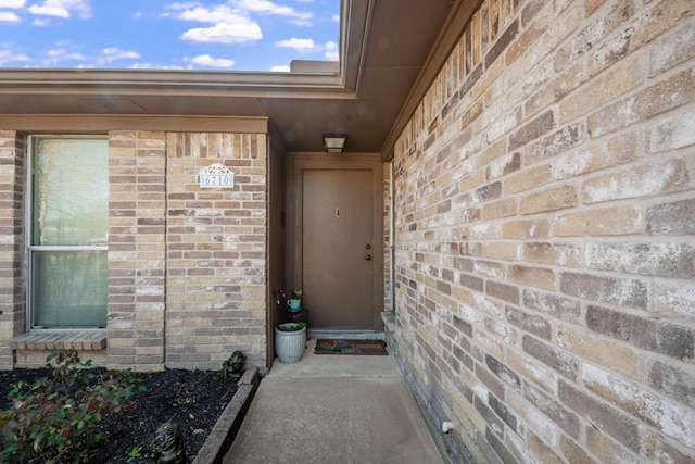 doorway to property with brick siding