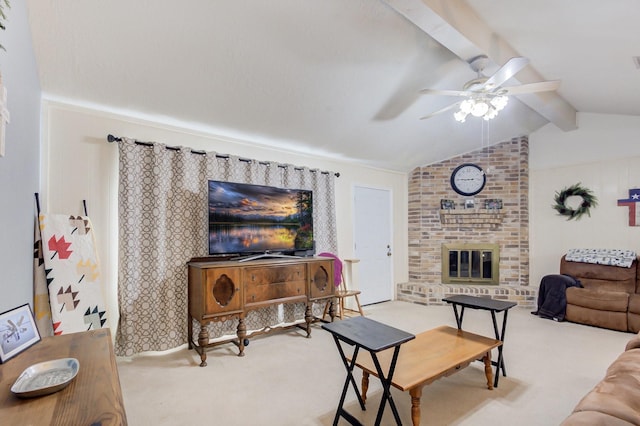 living room featuring lofted ceiling with beams, a brick fireplace, ceiling fan, and light colored carpet