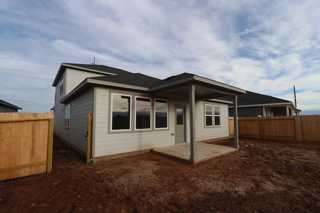 rear view of house featuring a patio area and a fenced backyard