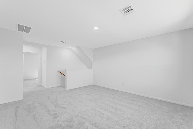 interior space featuring recessed lighting, visible vents, and light colored carpet