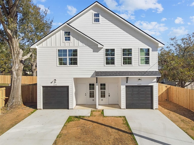 view of front of property with a garage, fence, board and batten siding, and concrete driveway