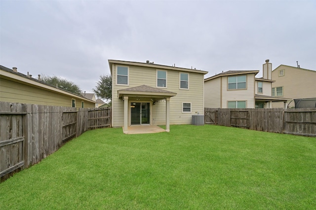 rear view of house featuring a patio area, a fenced backyard, a yard, and central AC unit