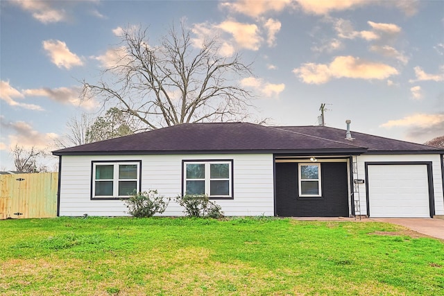ranch-style house with fence, concrete driveway, an attached garage, roof with shingles, and a front yard