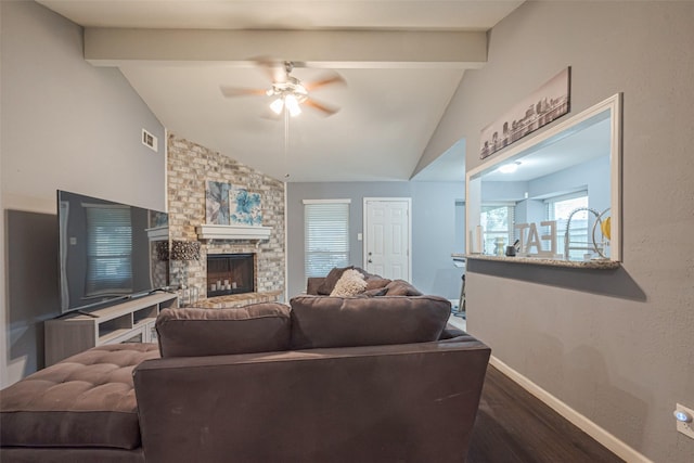 living area with vaulted ceiling with beams, a large fireplace, dark wood-style flooring, visible vents, and baseboards