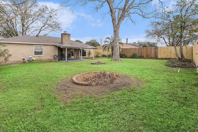 view of yard with a patio area and a fenced backyard