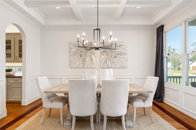 dining room with beam ceiling, coffered ceiling, and light wood-style flooring