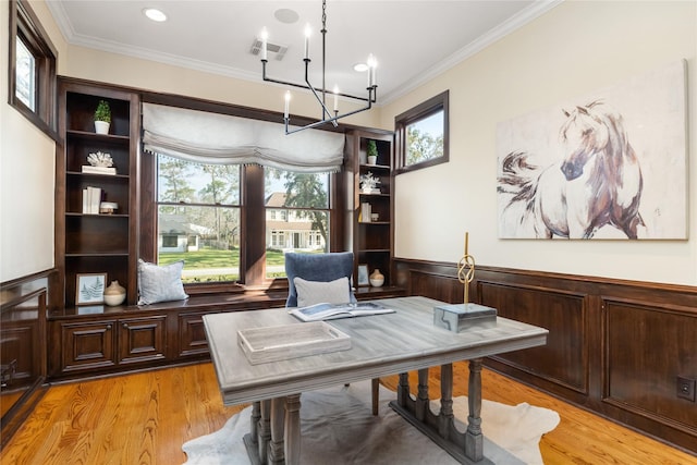 office space featuring visible vents, light wood-style flooring, and crown molding