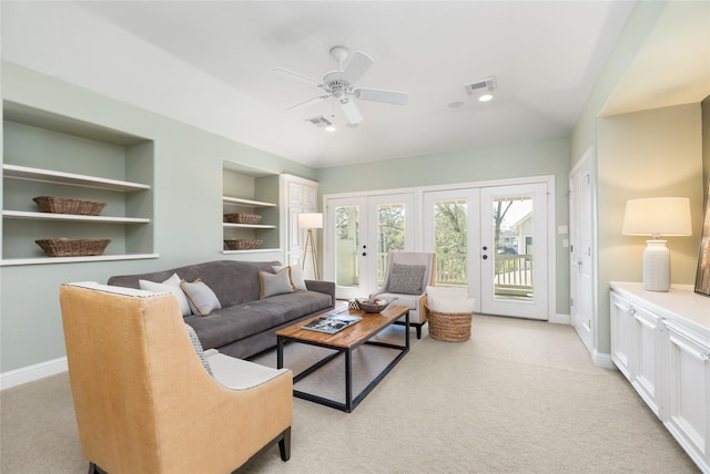 living area with light carpet, baseboards, visible vents, built in features, and french doors