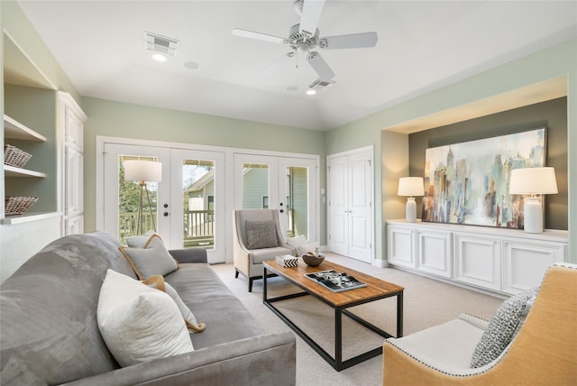 living room featuring light carpet, baseboards, visible vents, and french doors