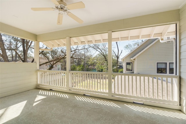 unfurnished sunroom with a ceiling fan