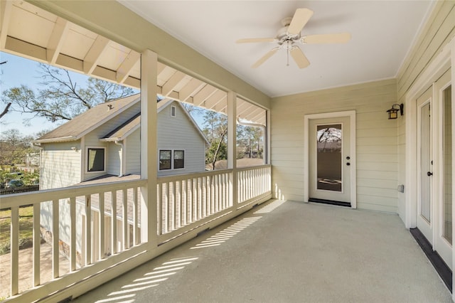 sunroom / solarium with a ceiling fan