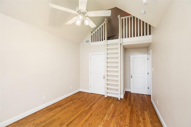 unfurnished bedroom featuring a ceiling fan, wood finished floors, visible vents, and baseboards