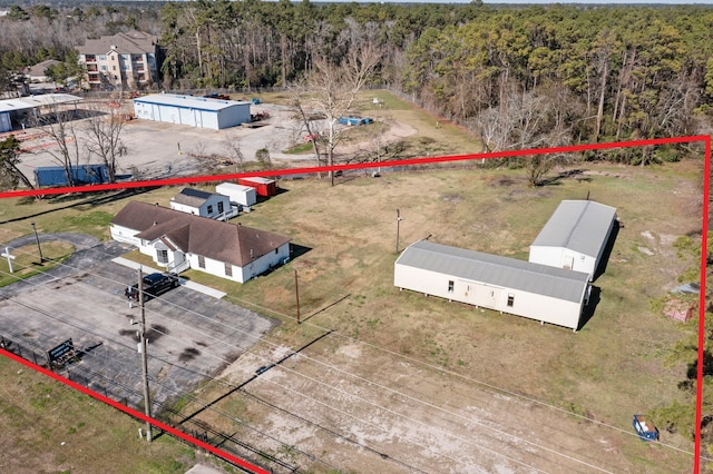 birds eye view of property featuring a view of trees