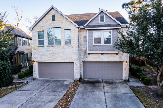 view of front of home with an attached garage and concrete driveway