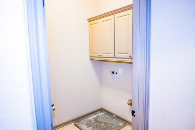 laundry room with washer hookup, cabinet space, and baseboards