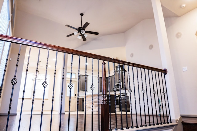 stairway with vaulted ceiling and a ceiling fan